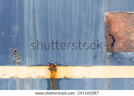 Beige Color strip on blue steel metal with water erosion drip, yellow brown rust, color fade, crack and tears