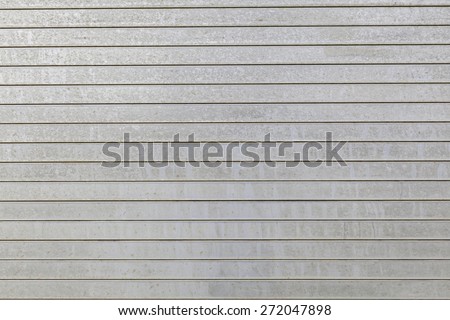 Metal aluminum siding wall horizontal stripes aged rust spots