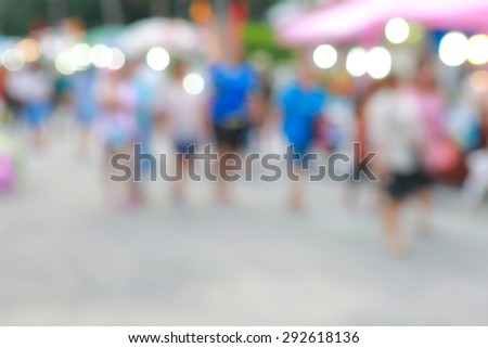 blurred people walking in outdoor shopping centre