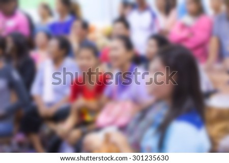 blurred people at show in hall for background usage