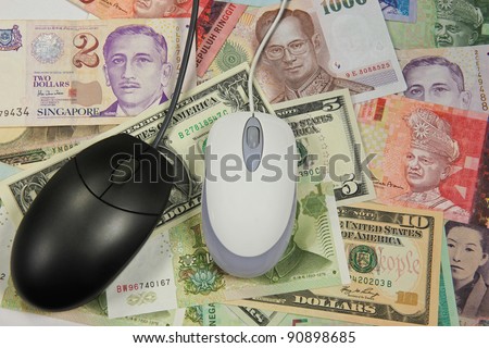 Two computer mouses on money