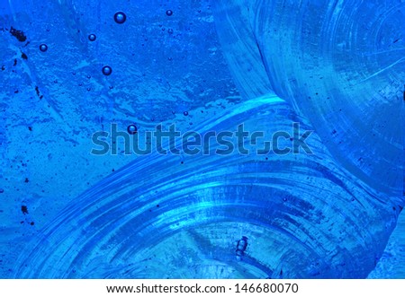 Blue background: closeup of abstract design in a piece of chipped slab glass in a stained glass window
