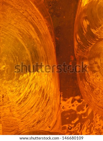 Abstract background: closeup detail of piece of orange chipped slab glass in a stained glass window