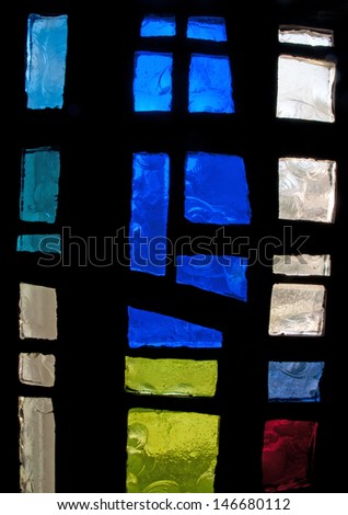 Abstract modern stained glass window made of chipped slab glass, located in Saint Benedict\'s Monastery, Winnipeg, Manitoba, Canada, designed by the late Gabriel Loire of Chartres, France