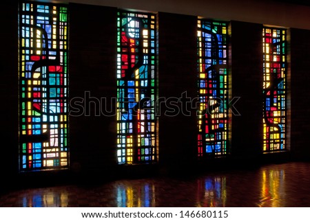 Four stained glass windows and reflections in chapel of Saint Benedict\'s Monastery, Winnipeg, Manitoba, Canada, designed by the late Gabriel Loire of Chartres, France
