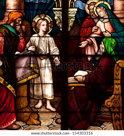 Stained glass window depicting the Bible story of the child Jesus lost in the temple