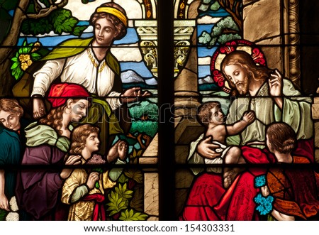 Stained Glass Window Depicting The Bible Story Of Jesus Christ With The Little Children