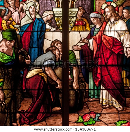 Stained glass window depicting Bible story of wedding feast of Cana, Jesus turning water into wine