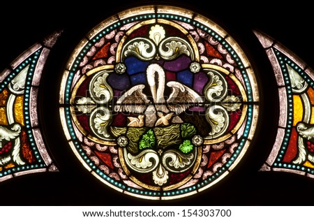 Round Stained Glass Window Depicting Christian Legend Of Pelican-In-Her-Piety Symbol