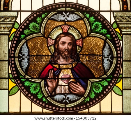 Round stained glass window depicting Sacred Heart of Jesus