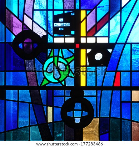 Modern stained glass window with cross and crossed keys, traditional Christian symbol of keys to the kingdom of God and of church authority