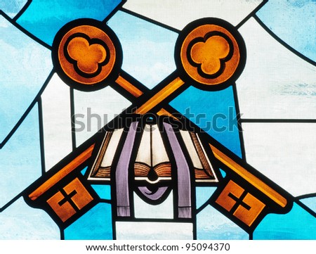 Stained glass window of Bible, priest\'s stole and keys
