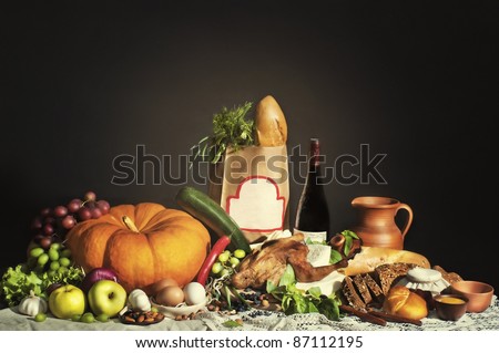 Still life with grocery bag and blank frame. Stock of food on the table with brown bag in the middle