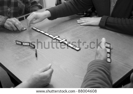 Four persons playing dominos