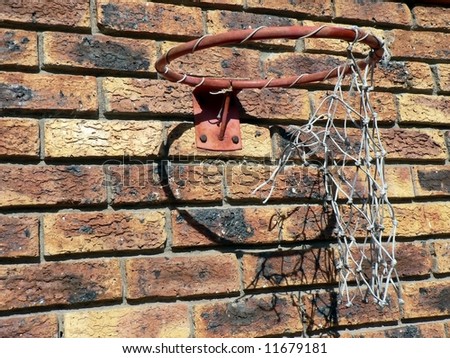 Old broken basketball hoop in need of repair.