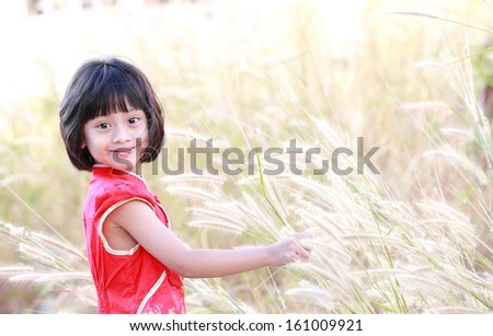 cute lovely sweet asian chinese kid girl with smiling face on the road.Chinese girl play in the park,Portrait of little Asian girl