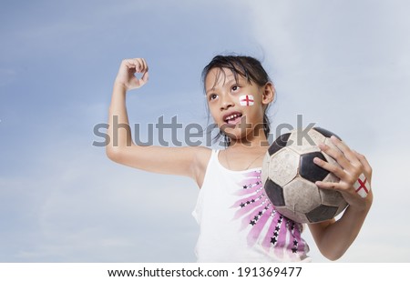 Young Girls Like Football with painted face and holding a ball
