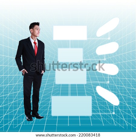 Young Businessman Standing Smiling Full Body Length looking on a touch screen interface.