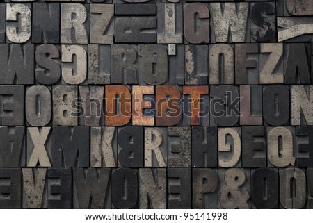 The word Debt written in antique letterpress printing blocks.