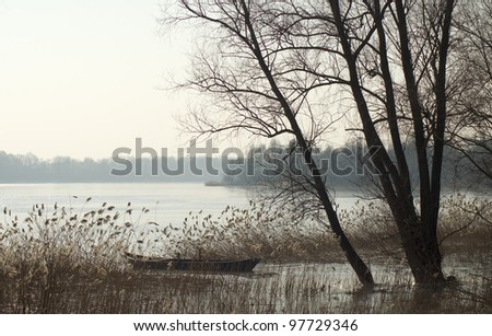 Early spring - lake, boat and thaw