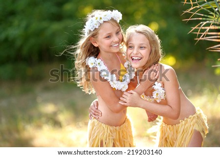 portrait of two sisters twins in tropical style