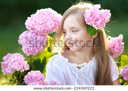 portrait of little girl with flowers hydrangea