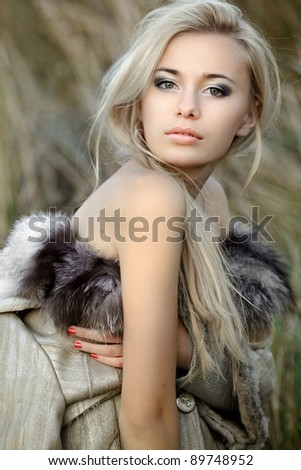 girl in a fur coat in the autumn background