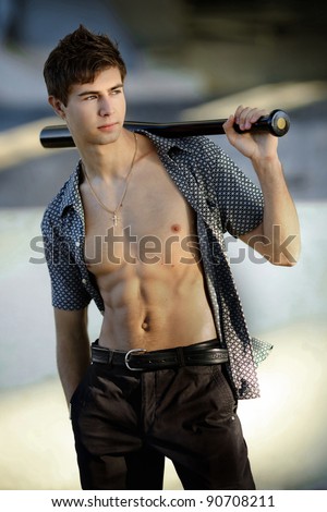 attractive young man with a baseball bat