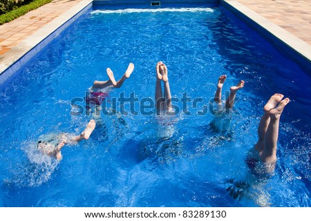 Kids feet in the air in swimming pool