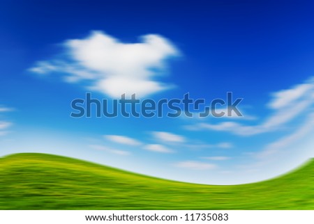 Blurred large piece of land and blue cloudy sky (can be used how background or wallpaper)
