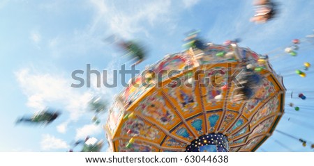People enjoying their ride in a  classic Chair-O-Planes at the fair
