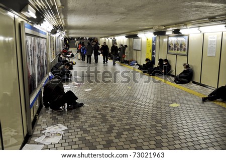 TOKYO - MAR 11: People spending the night in the subway on March 11, 2011 in Tokyo, Japan. Millions of people can\'t get home as all trains and subway trains have stopped because of the earthquake.