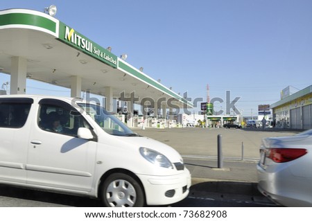 IBARAKI PREFECTURE, JAPAN - CIRCA MAR 2011: Hundreds of cars wait in line for the closed gas station to reopen in Ibaraki Prefecture circa March 2011. After the earthquake, there is a shortage of fuel