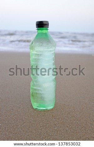 disused beverage bottle on the beach at the seaside, north china