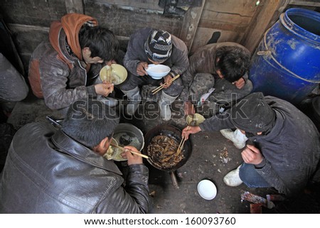 Luannan County, April 1: Workers were having lunch in the cabin of fishing boat in the ZuiDong fishing Wharf on April 1, 2012, Luannan County, Hebei Province, China.
