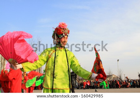 LUANNAN COUNTY, CHINA, February 4: people wearing colorful clothing, with various props, performing in the streets in Yangko dance on February 4, 2012, Luannan County, Hebei Province, China.