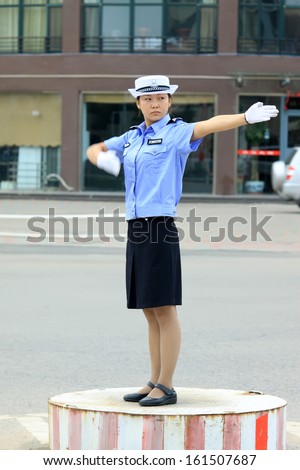 LUANNAN COUNTY - SEPTEMBER 16: Female traffic police were directing traffic in the street on September 16, 2011, luannan county, Hebei province, China.