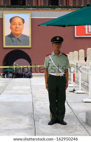BEIJING - August 29: A soldier stands guard while people visit the Palace Museum on August 29, 2011 in Beijing, China.