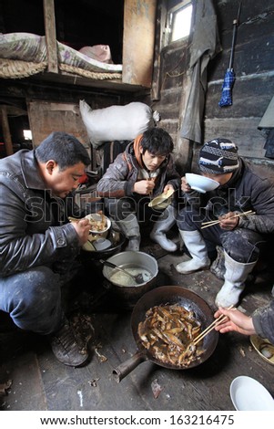 LUANNAN COUNTY - APRIL 1: Workers were having lunch in the cabin of fishing boat in the ZuiDong fishing Wharf on April 1, 2012, Luannan County, Hebei Province, China.