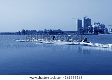 LUANNAN - JUNE 14: Several workers were putting in order dragon boats in water, in the North River Park on June 14, 2013, Luannan, Hebei Province, China.