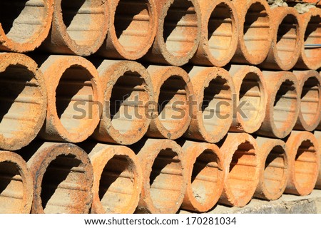 clay drain pipe stacked together in a warehouse