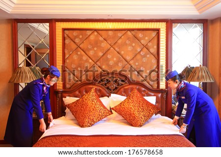 LUANNAN, CHINA - NOV 20:  Lanhai Hotel service personnel finishing room, November 20, 2012. The Lanhai Hotel is the largest catering service company in the local.