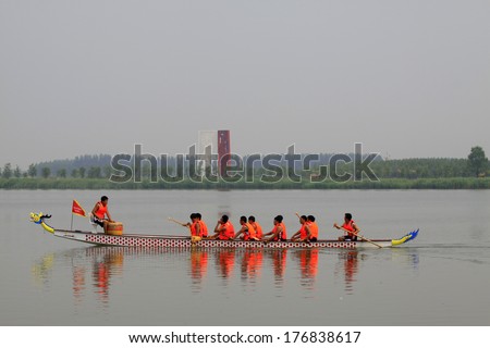 LUANNAN - JUNE 15: The dragon boat race scene in Chinese traditional Dragon Boat Festival on June 15, 2013, Luannan, Hebei Province, China.