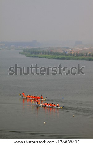 LUANNAN - JUNE 13: The dragon boat race scene in Chinese traditional Dragon Boat Festival on June 13, 2013, Luannan, Hebei Province, China.
