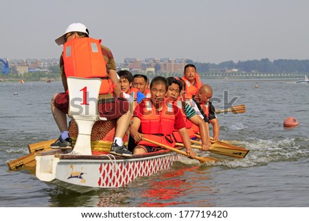 LUANNAN - MAY 31: Dragon boat race scene in Chinese traditional Dragon Boat Festival on May 31, 2013, Luannan, Hebei Province, China.