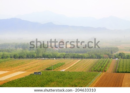 ZUNHUA MAY 18: Cultivated land and ancient landscape, Eastern Tombs of the Qing Dynasty on may 18, 2014, Zunhua county, Hebei Province, China.