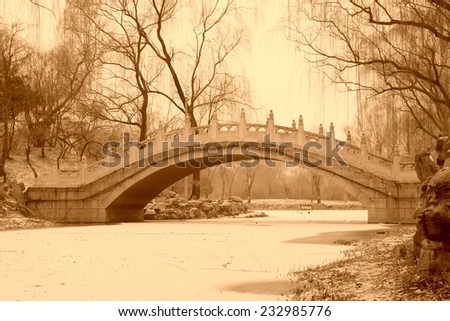 Stone arch bridge building landscape in winter in Old summer palace ruins park, Beijing, China