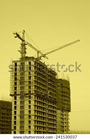 tower crane and unfinished building under the blue sky, in a building site, China