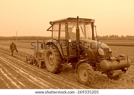 Luannan County, May 7: Farmers use new agricultural machinery sowing peanut in ShuangLiu Tree village on May 7, 2012, Luannan County, Hebei Province, China