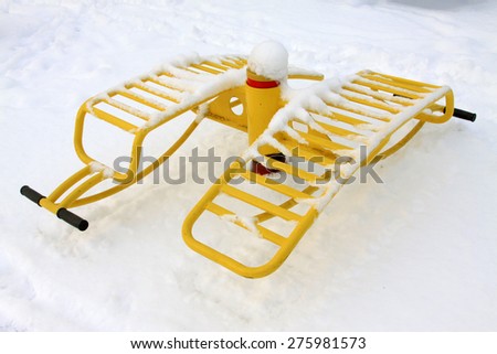 Yellow fitness facilities in the snow, closeup of photo